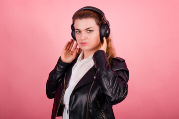 Woman with headphones, listening to music, fashion model in studio posing, music genre, smiling,...