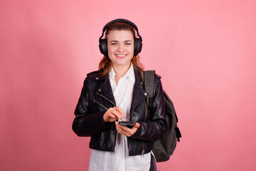 Woman with headphones, listening to music, fashion model in studio posing, music genre, smiling,...