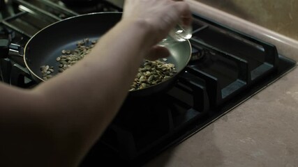 This demonstration shows how to toast seeds in a skillet, detailing the process from adding seeds to the heated pan to checking their doneness, including essential tips to elevate your cooking skills