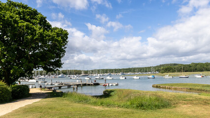 Quiet river scene with pleasure boats at moorings. UK.
