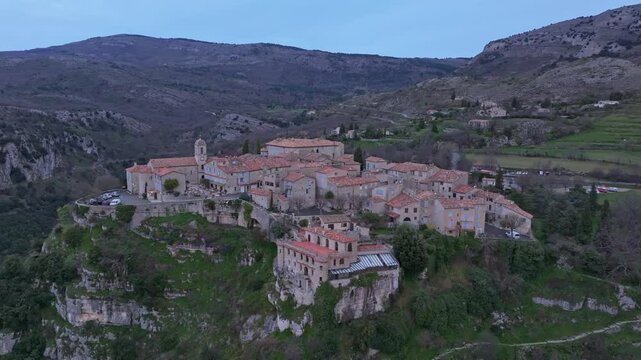 Aerial view of French castle and rooftops bathed in early light, Gourdon. Aerial drone video