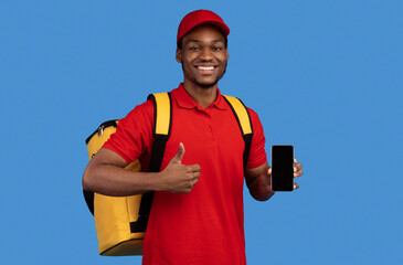 Food Delivery. African american courier man holding mobile phone with blank screen for mockup,...