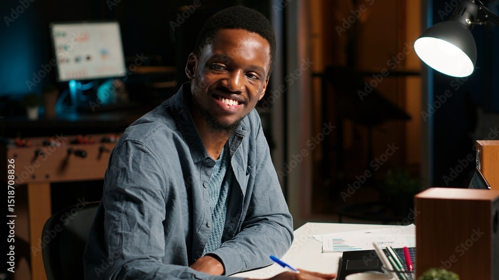 Poster african american freelancer working from home writing notes and researching data driven topics. focu