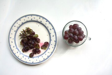 Grapes in a plate on a white background. Isolated