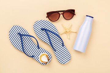 Striped blue flip flops with accessories on color background, top view