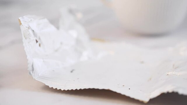 Eating a chocolate and dulce de leche alfajor from the original packaging.