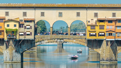 The Ponte Vecchio on a sunny day timelapse, a medieval stone segmental arch bridge over the Arno River, in Florence, Italy
