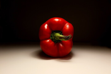 Back view of a fresh red bell pepper with stem on white background, photographed under studio lighting – minimal food composition for healthy eating, cooking, or vegetarian lifestyle concepts