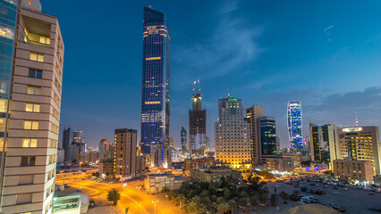 Skyline with Skyscrapers day to night timelapse in Kuwait City downtown illuminated at dusk. Kuwait City, Middle East