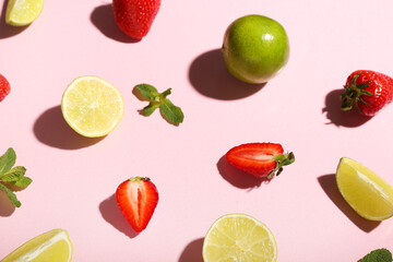 Fresh strawberries with lime and mint on pink background