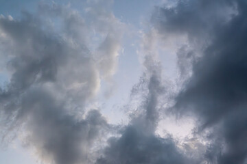 Dramatic cloudy sky before a storm, with swirling dark and light cloud formations. Ideal for background or texture use.