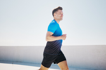 Runner enjoys a sunny morning jog along a bright, open rooftop with clear blue skies above