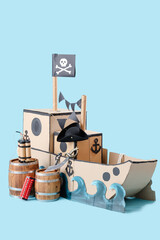 Pirate cardboard ship with explosive on blue background