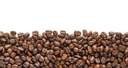Many roasted coffee beans on white background. Coffee beans border with area for copy space. Close up images.