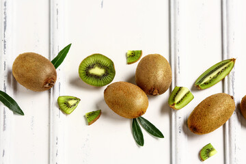 Fresh kiwi and leaves on white background