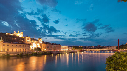 Fototapeta premium Timelapse of Saint John the Baptist Cathedral and Basilica of Notre-Dame de Fourviere in Lyon, from day to night. France