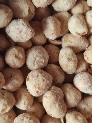 close up nuts, flour-coated nuts, isolated brown background