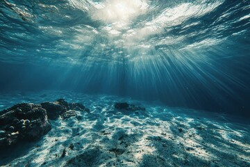 Mesmerizing underwater scene: sunbeams illuminate ocean floor, coral reef, and sandy seabed. stunning underwater photography showcasing the beauty of marine life and sunlight's ethereal effect.