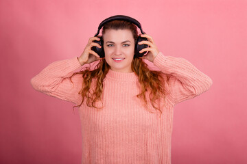 Woman with headphones, listening to music, fashion model in studio posing, music genre, smiling,...