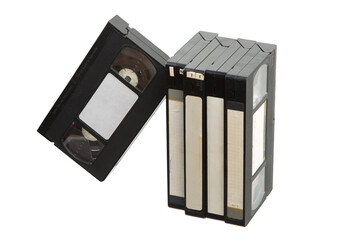 Group of vintage VHS video tapes with blank labels, standing and leaning on white back