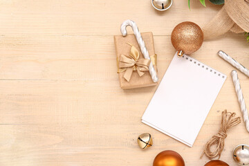 Blank paper calendar with gift box and Christmas decorations on wooden background