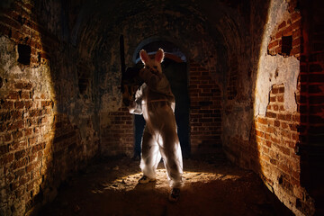 Maniac in mask of scary rabbit with chainsaw