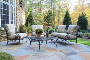 Obraz premium Cozy outdoor seating area with stylish furniture, surrounded by lush greenery and trees