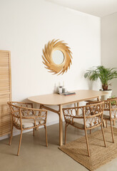 Interior of dining room with golden mirror and table
