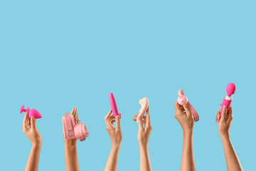 Women with pink sex toys on blue background