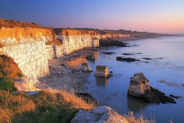 Coastal cliffs at sunrise, with calm water
