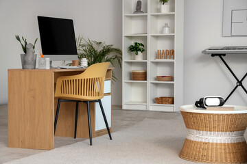 Workplace with modern computer in living room