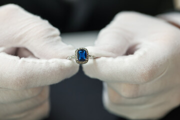 Appraiser working with luxury ring at table, closeup
