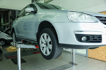 Lifted automobile during tire change at car service