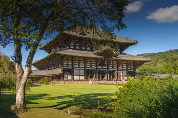 Nara, Japan - Sep 26 2024, Panoramic view of Todaiji Temple with lawn and trees in the foreground, at daytime with clear blue sky, Nara, Japan