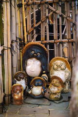 Nara, Japan - Sep 26 2024, vertical, A close-up view of a group of tanuki statues, creatures from...