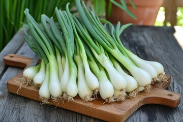 Fresh spring onions on a wooden cutting board