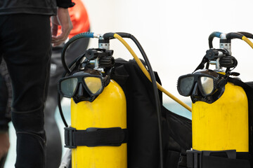 Scuba diving equipment on swimming pool.Diving mask and yellow oxygen tank for water rescue...