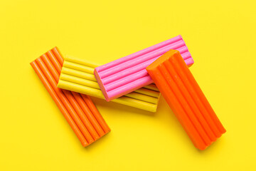 Fototapeta premium Colorful plasticine on yellow background