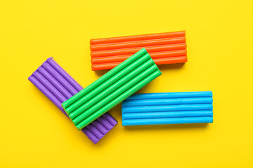 Colorful plasticine on yellow background