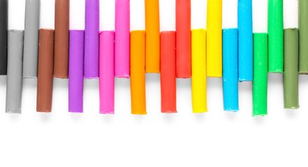 Many colorful plasticine on white background