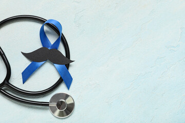 Blue ribbon with stethoscope and paper mustache on light grunge background. Prostate cancer...