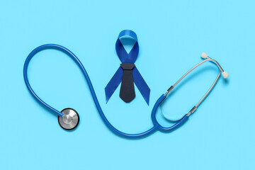 Blue ribbon with stethoscope and tie on color background. Prostate cancer awareness concept