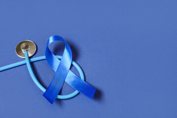 Blue ribbon with stethoscope on color background. Prostate cancer awareness concept