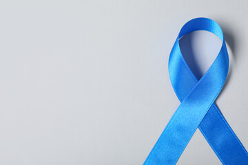 Blue ribbon on grey background. Prostate cancer awareness concept