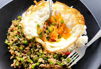 Stir-fried pork with holy basil with egg in plate