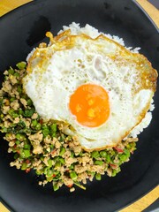 Stir-fried pork with holy basil with egg in plate