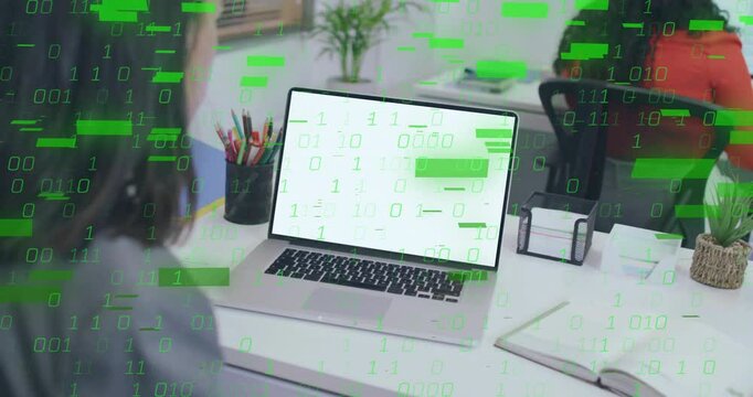 Business professional facing laptop with green binary code emerging on screen and enveloping desk