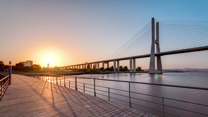 Vasco da Gama bridge during sunset and ebb-tide in Lisbon, Portugal. Timelapse