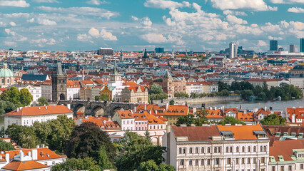 Obraz premium Panorama of Prague Old Town with red roofs timelapse, famous Charles bridge and Vltava river, Czech Republic.