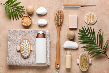 Beautiful composition with different spa supplies and palm leaves on beige background